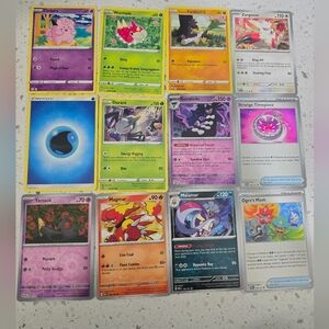 Pokemon assorted card lot with purple, yellow, green, blue, orange, pink,12 card